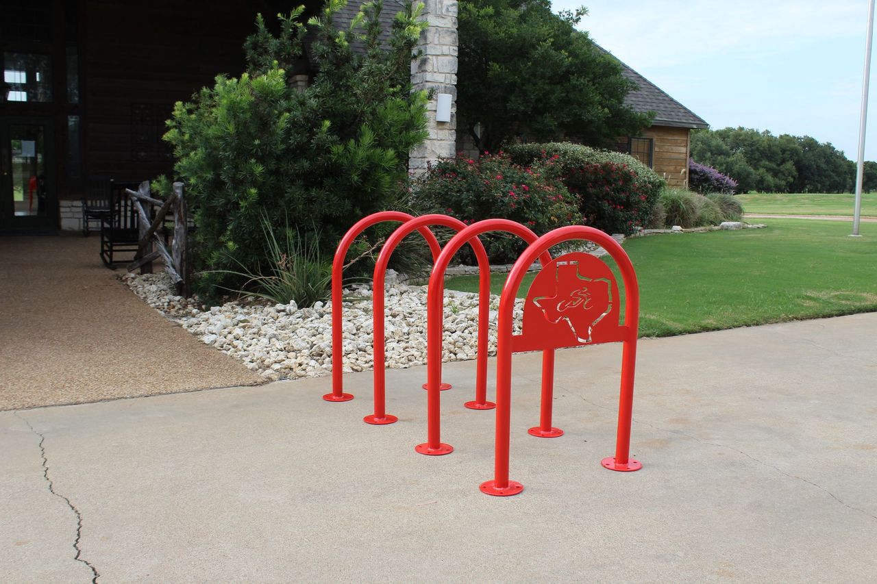4 Custom Red MyTCoat 1.90" U Bike Racks with Surface Mount Lifestyle Image