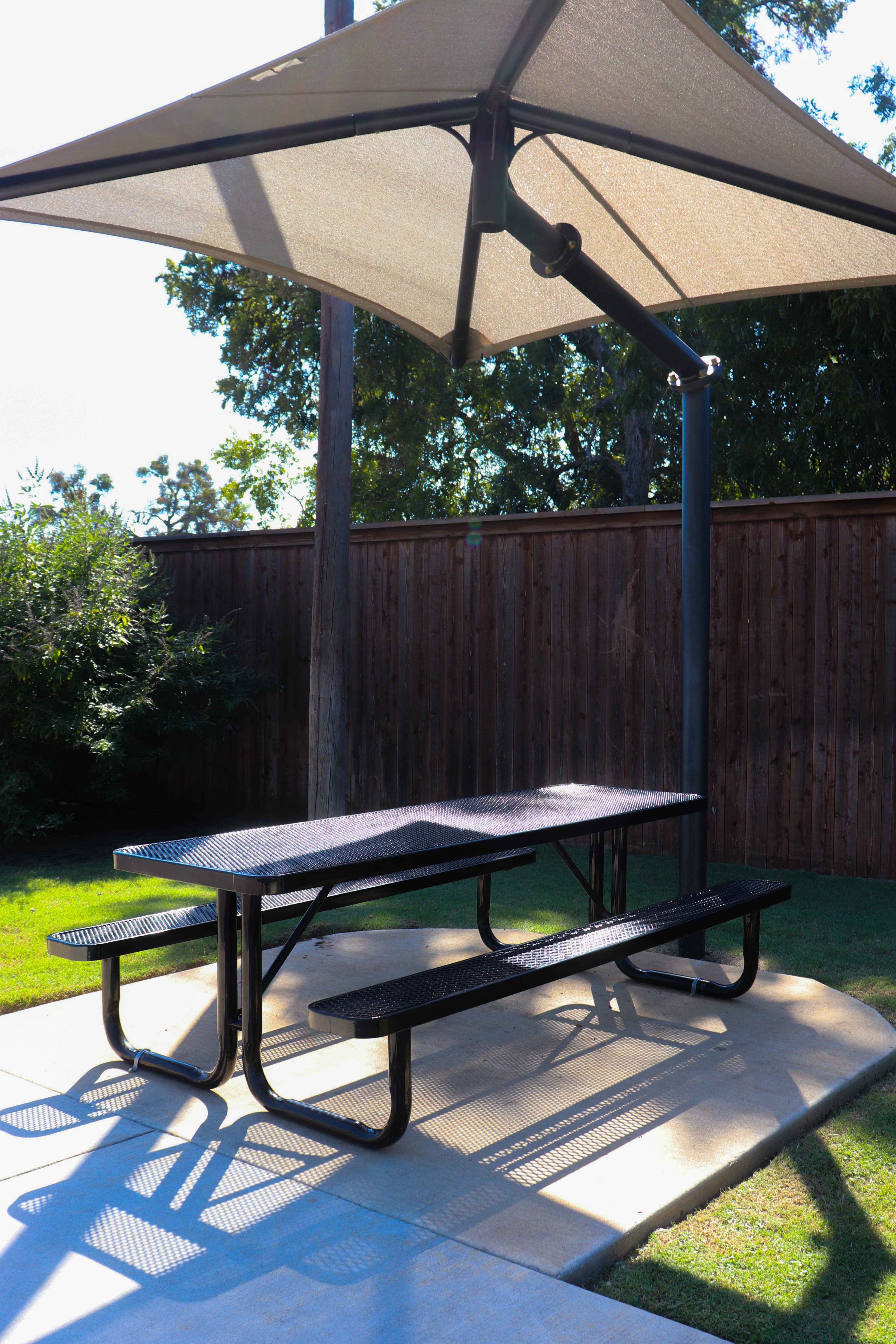 Black MyTCoat Rectangular Portable Picnic Table Under Umbrella Shade Lifestyle Image