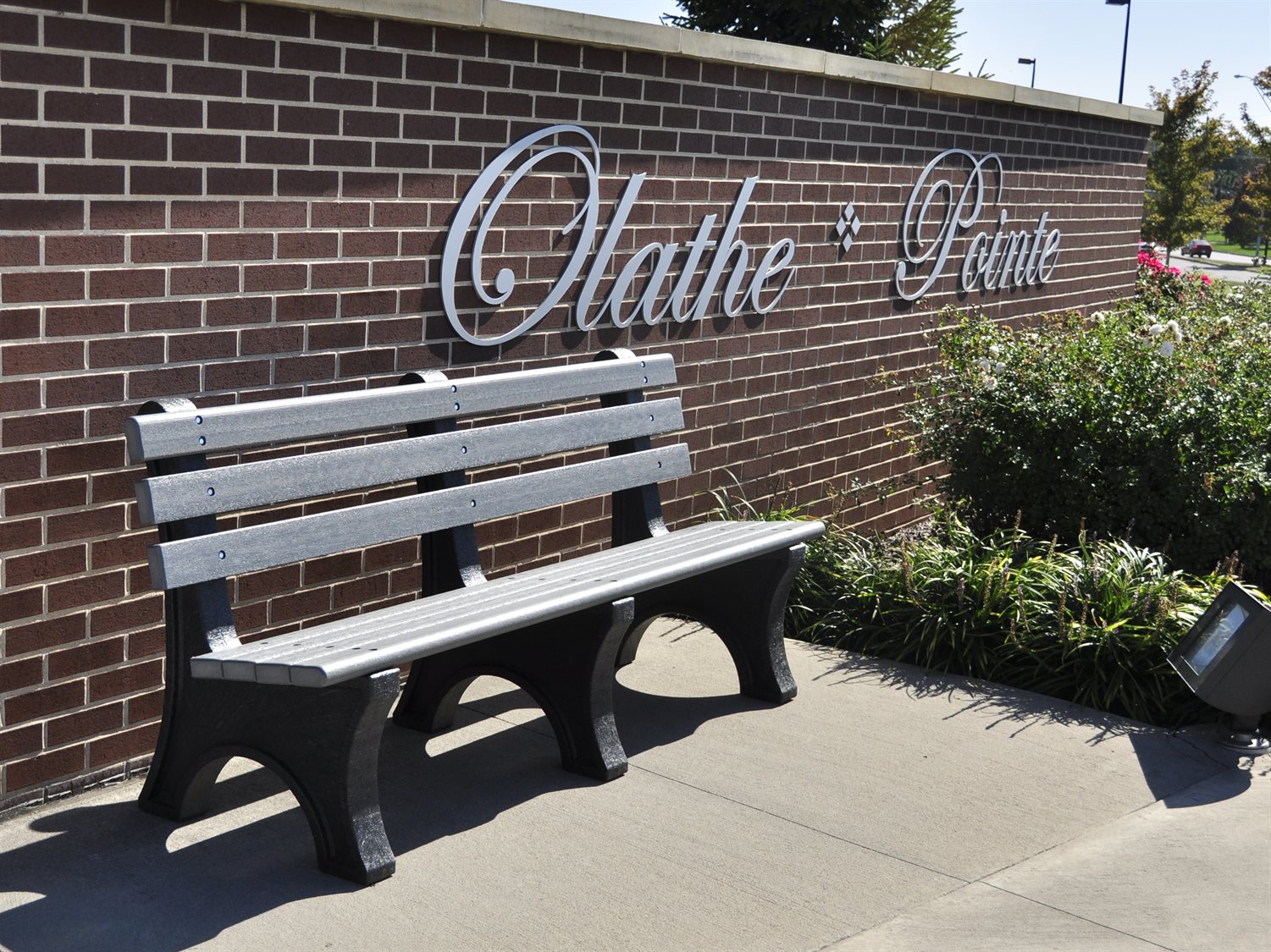 Frog Furnishings Gray Comfort Park Bench 6' Option Environmental Photo With Campus Background