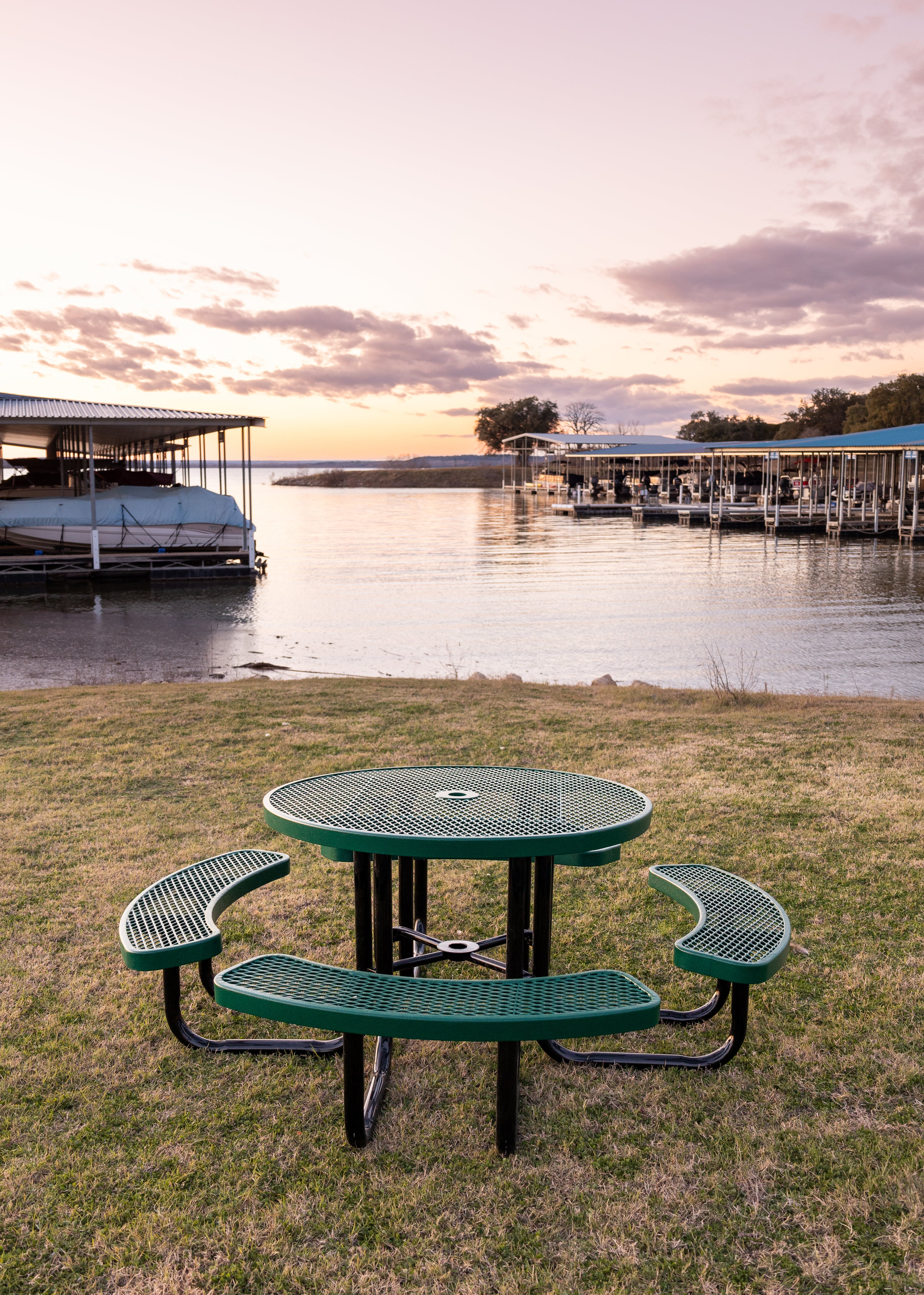 Green MyTCoat Round Portable Picnic Table Lifestyle Image with Boat Dock Background