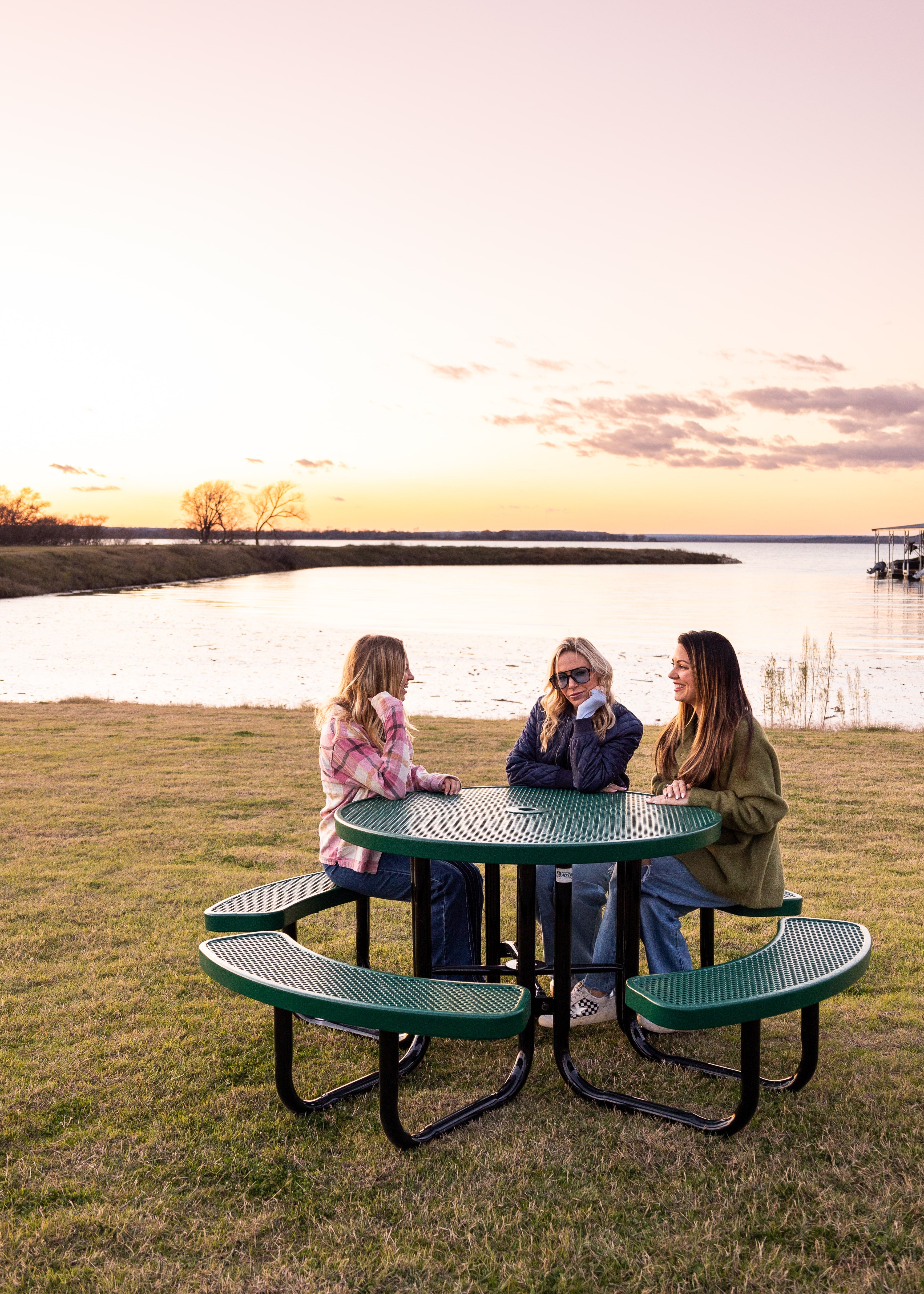 Green MyTCoat Round Portable Picnic Table Lifestyle Image with River Background and People Sitting