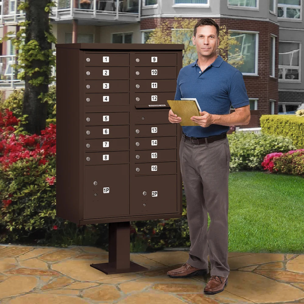 Man in Neighborhood standing next to a brown Salsbury USPS Mailbox Cluster Unit with 16 Doors and 2 Parcel Lockers.