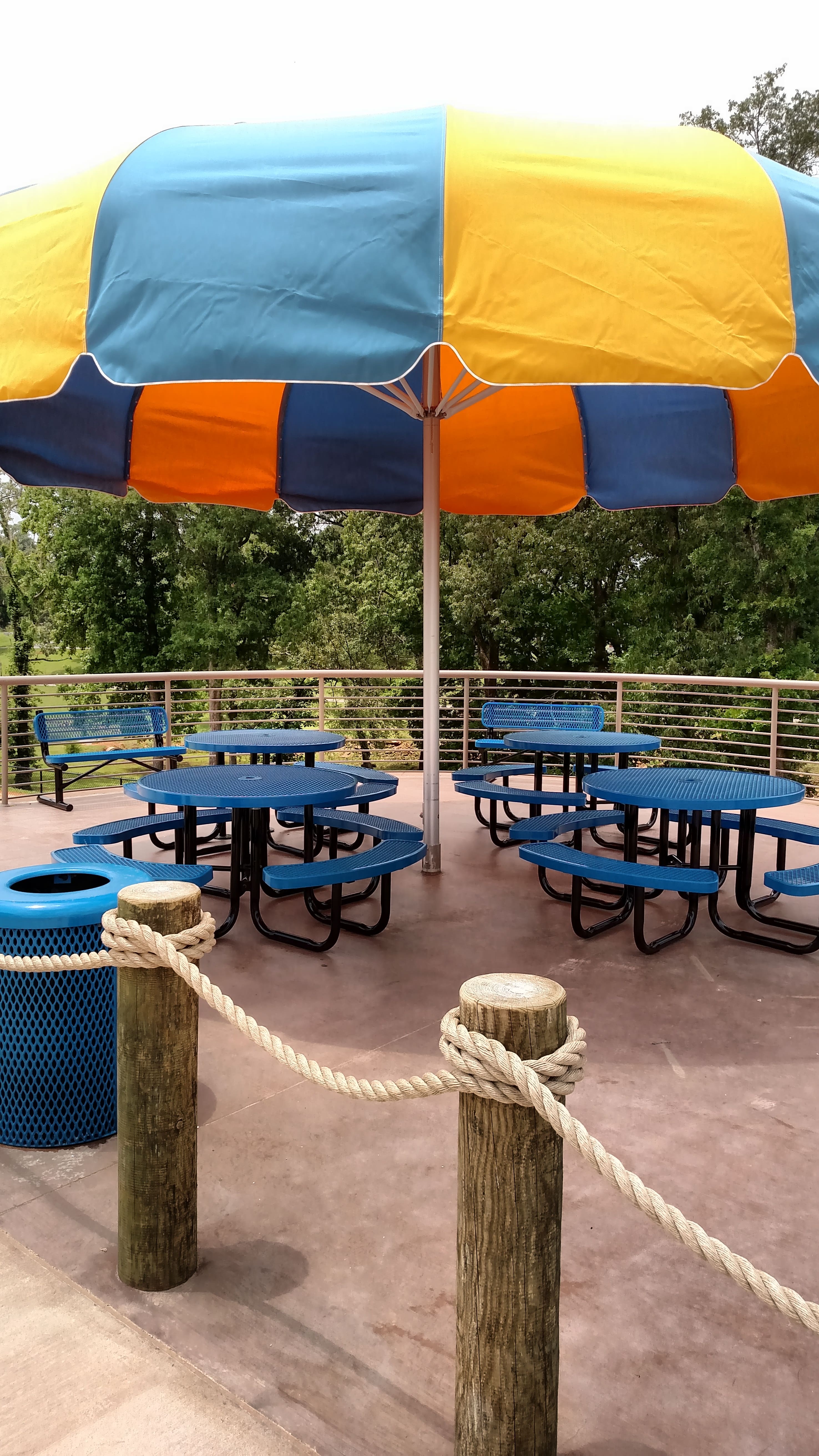 Mulitiple Blue MyTCoat Round Portable Picnic Tables Lifestyle Image at Waterpark