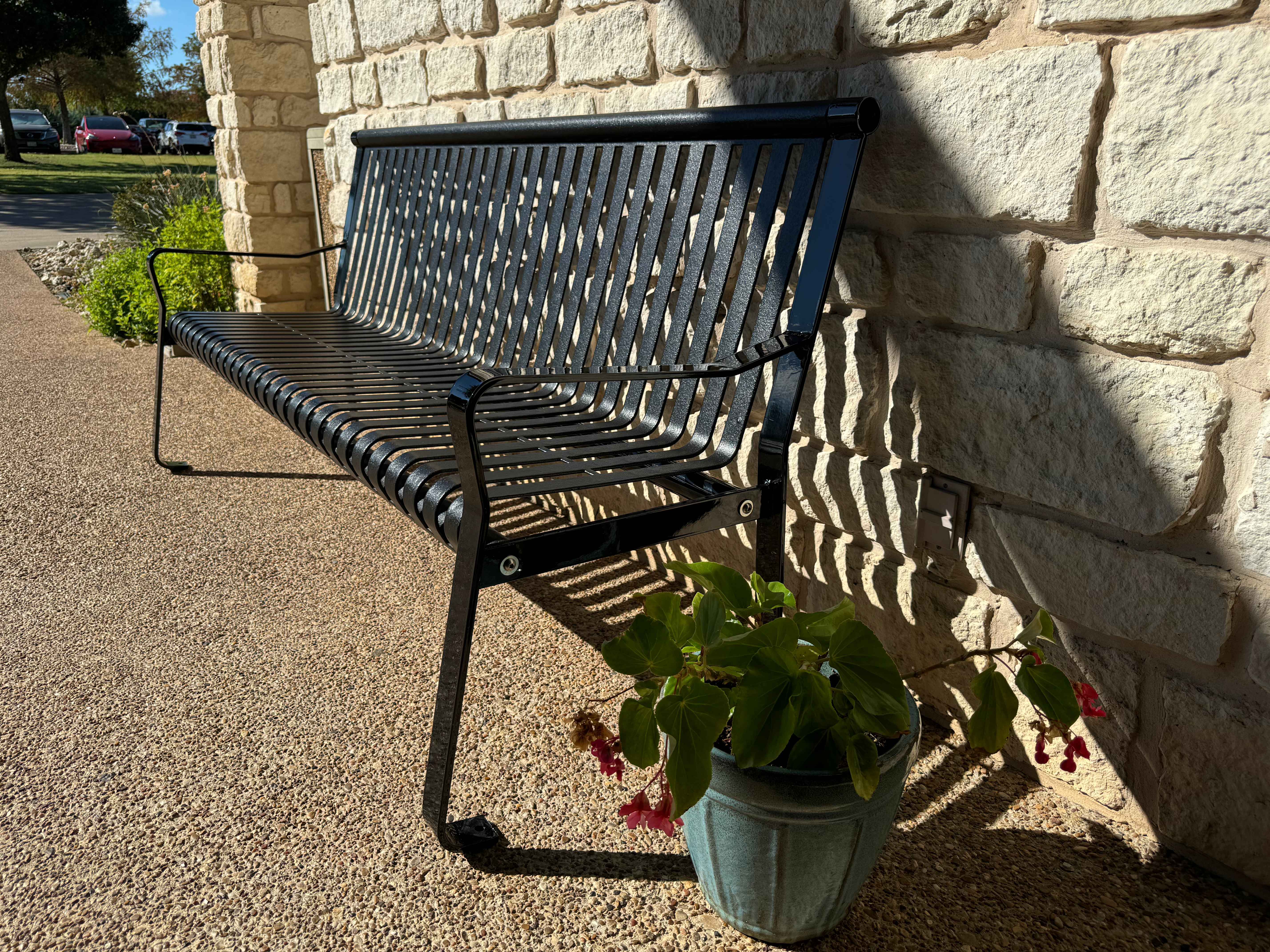 MyTCoat Metal Downtown Park Bench with Back Lifestyle Image with Flower Pot Beside