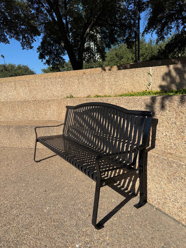 MyTCoat Metal Park Skyline Bench Lifestyle Image with Rock Steps Background