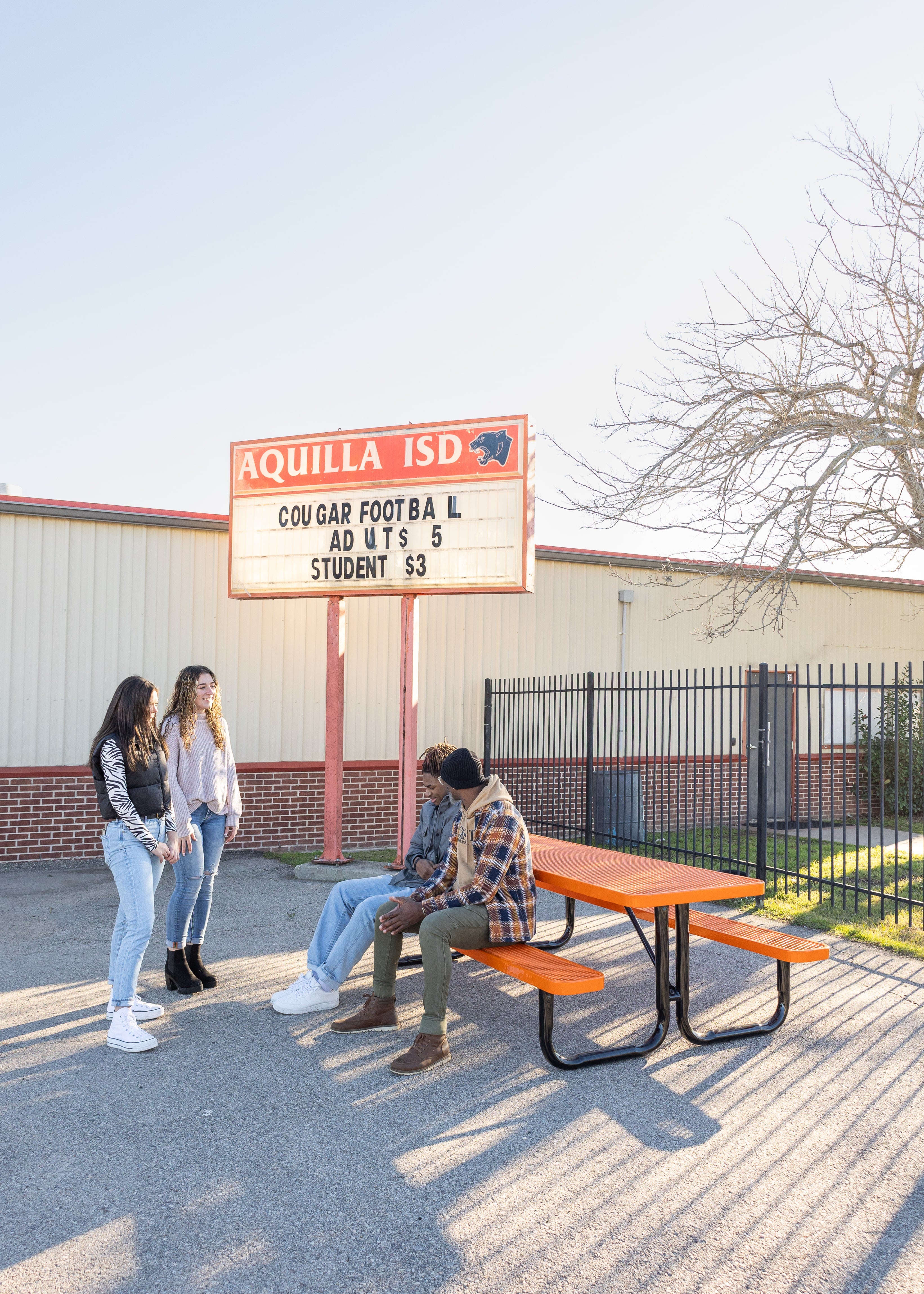 Orange Blue MyTCoat Rectangular Portable Picnic Table with People Sitting and School Courtyard Background Lifestyle Image