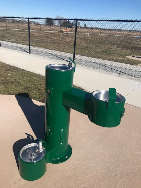 Stern-Williams 5700 ADA Single Outdoor Drinking Fountain with Two Separate Spouts with Pet bowl attached and park background