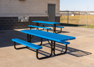 Two Blue MyTCoat ADA Accessible Rectangular Portable Picnic Table Beside Bleachers with Open Field Background Lifestyle Image