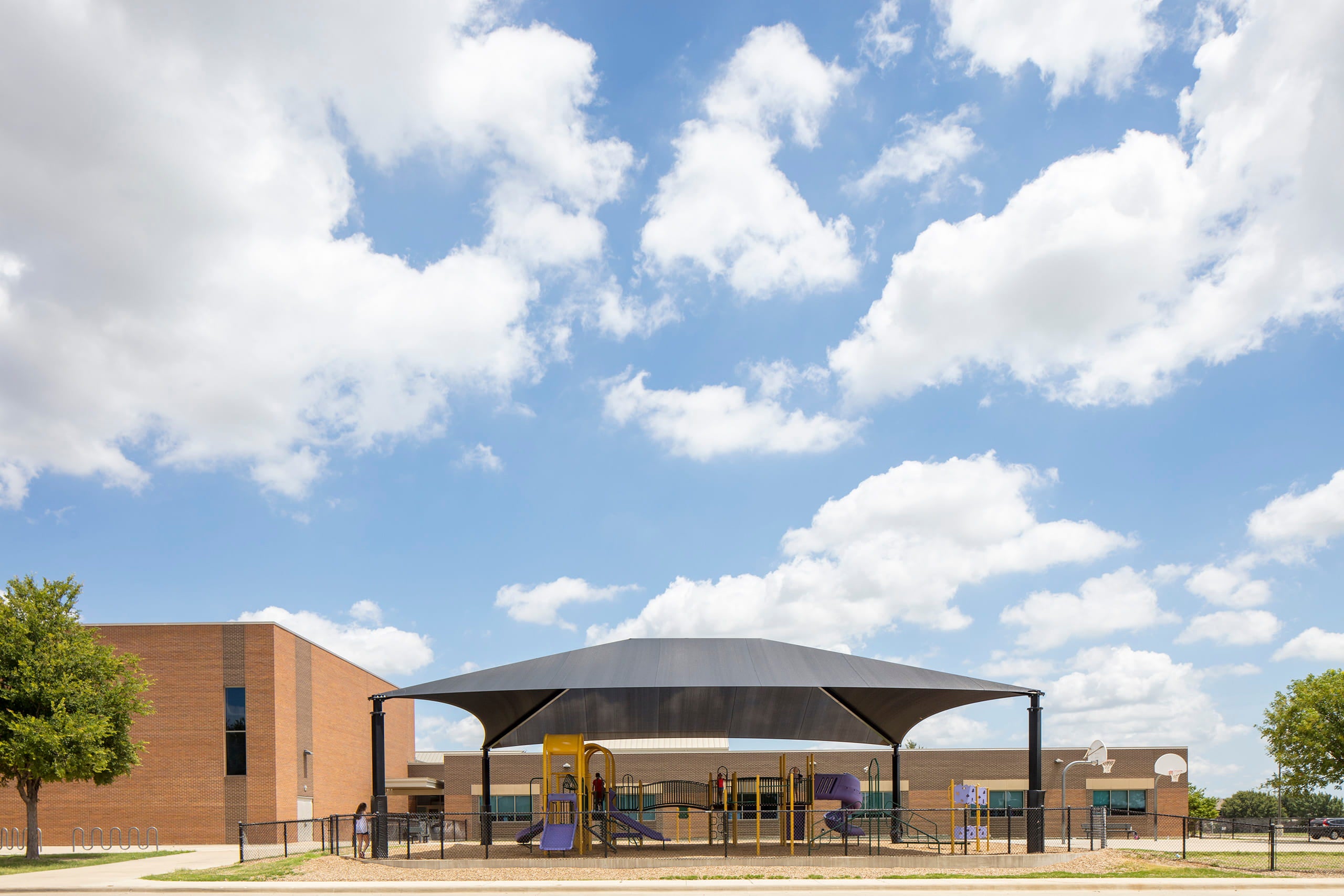 School building with a large USA Shade Hip on a sunny day