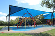 Children's playground with colorful equipment under a blue USA Shade Hip on a sunny day.