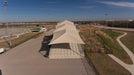 Large outdoor stairs covered by USA Shade Super Span Hips with a clear sky background