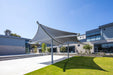 Modern architectural designed USA Shade Aquarius Shade with a large curved roof structure in an urban setting.