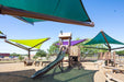 Children's playground with wooden structures, slides, and USA Shade Arbor Shade sails under a clear blue sky.