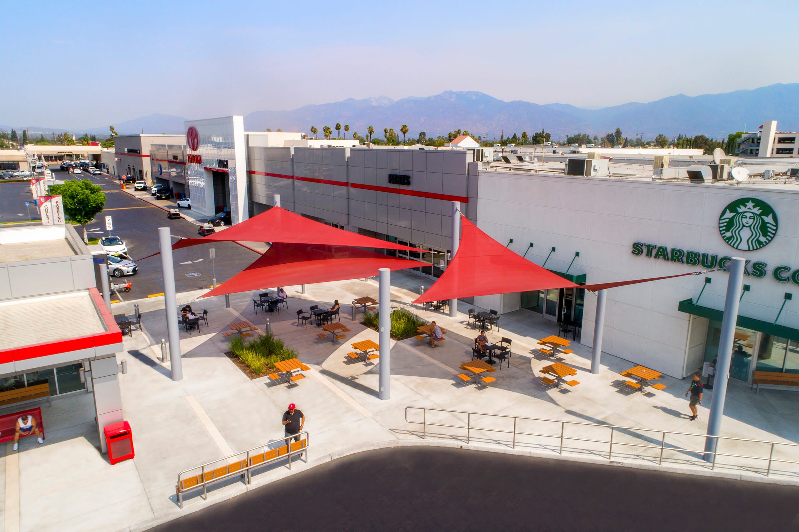 red USA Shade 3-Point Sail Shades at toyota and starbucks area