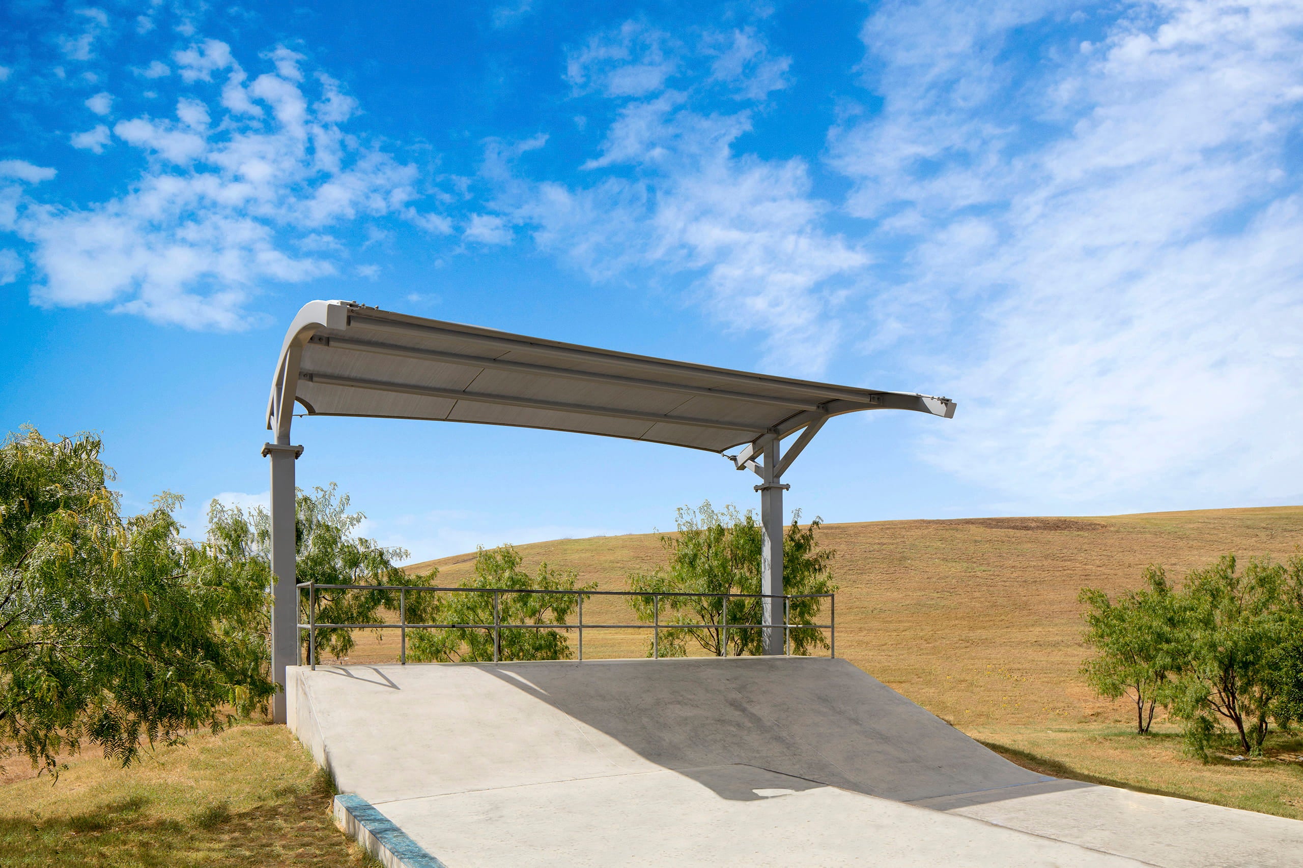 Covered Skate path with a metal USA Shade Panorama Cantilever against a blue sky