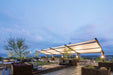 Outdoor rooftop deck with USA Shade Slanted Cantilever Cabled and evening skyline