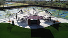 Outdoor pickleball courts with tables and chairs  under USA Shade Solana Cantilevers at a facility.