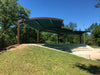 Outdoor amphitheater with a green USA Shade Panorama Cantilever in a park setting