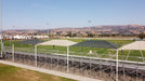 Outdoor sports facility with green USA Shade Hips and clear blue sky