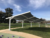 USA Shade Slanted Cantilever Cabled Covered outdoor area with a large canopy in a park setting