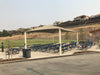 Picnic area with tables, benches, and a large USA Shade Hip in an outdoor setting.