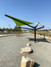 Green USA Shade Arbor Shade sail over a pathway with rocks and a clear blue sky