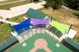 A sports court with colorful Cantilever Hypar shade sails and bleachers in an outdoor setting.
