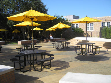 Black Wabash Valley Signature Round Picnic Tables with Diamond tops and yellow umbrellas in a school courtyard, a round picnic table with umbrella