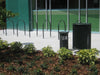 Black Wabash Valley Signature Diamond Commercial Trash Receptacle with Wabash Valley Bike racks and Ash Disposal Lifestyle image