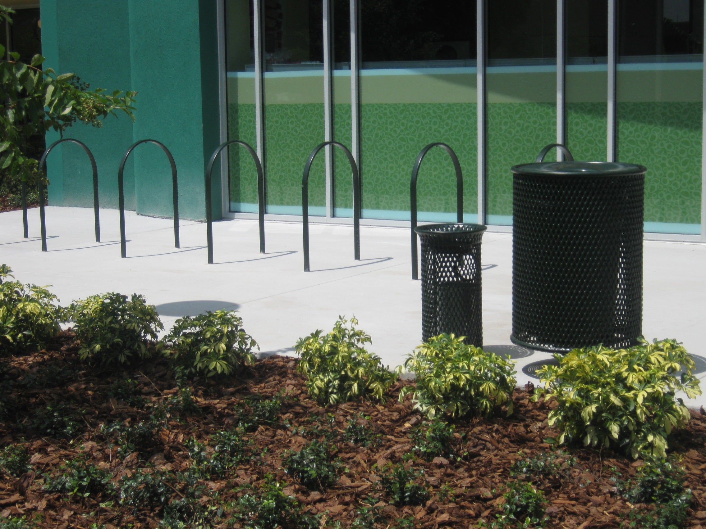 Black Wabash Valley Signature Diamond Commercial Trash Receptacle with Wabash Valley Bike racks and Ash Disposal Lifestyle image