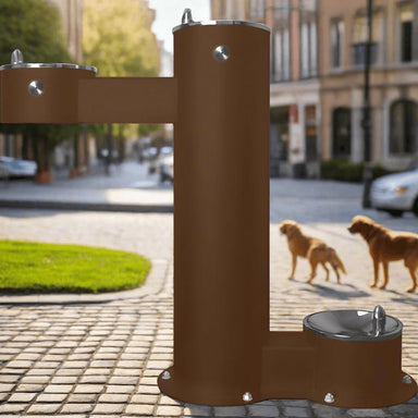 Brown Willoughby Free-standing Double Drinking Fountain Front Access, Adult Height, and Dog Bowl Options with two dogs walking in the background.