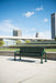 Green Wabash Valley Contemporary Perforated Steel Bench CN420P Surface Mount on a downtown civic plaza, public park bench in powder coated steel