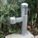 Metallic Gray Green Willoughby Stainless Side Approach Bottle Filler Drinking Fountain with bottle cap on a green leafy background