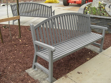 Silver Wabash Valley Arch Yorktown Aluminum Bench on a concrete pad in a mulched garden bed, model YO1213C, arched garden bench