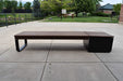 Front view of a Wabash Valley Liberty Modular Bench with Square Seat on a concrete patio, Thermory ash slats on black steel, model LBB002N, modular bench