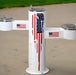 White Willoughby Triple Height Drinking Fountain Side Approach with American flag design on a concrete surface