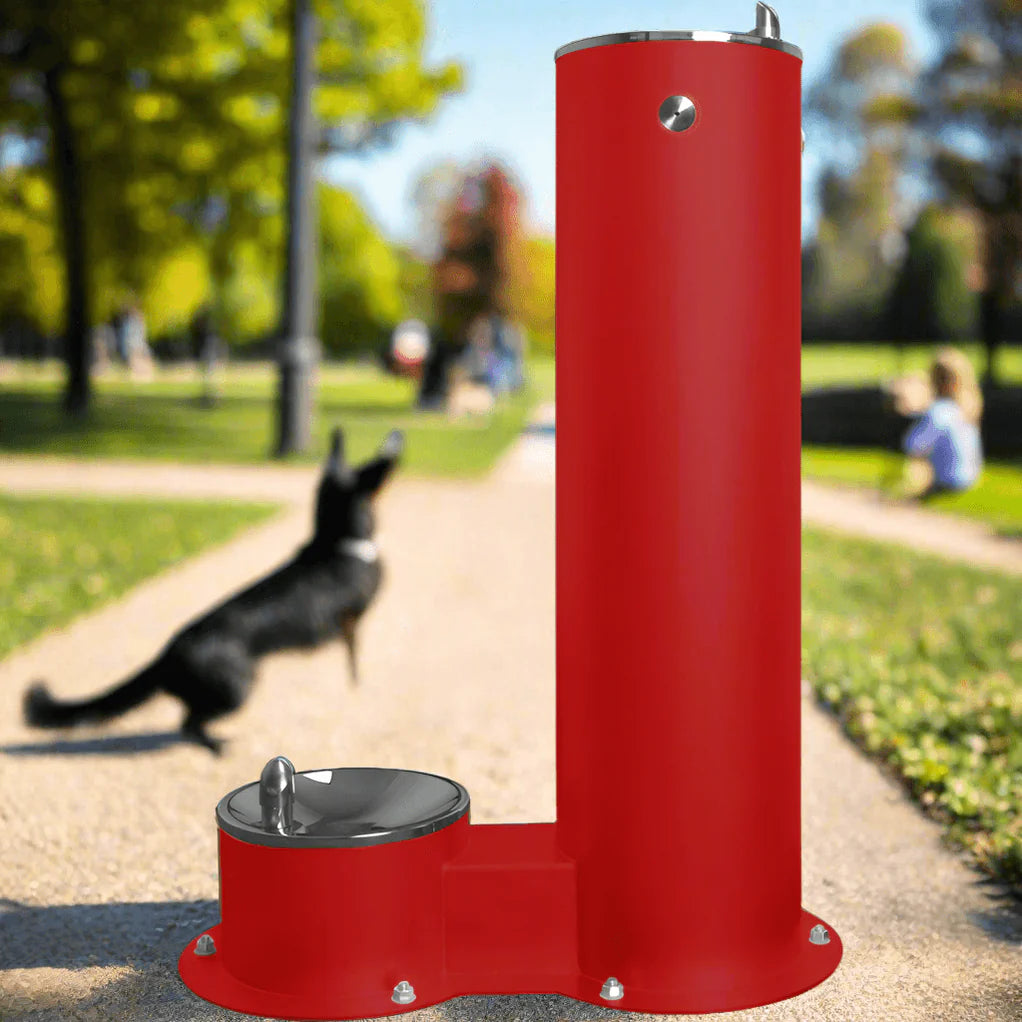 Willhoughby Single Outdoor Drinking Fountain with Added Dog Bowl Option in a park setting with a dog in the background.