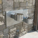 Willoughby Double Wall-Mounted Drinking Fountain mounted on a stone wall.