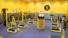 Yellow Wabash Valley Signature Perforated Commercial Trash Receptacle Inside of Planet Fitness