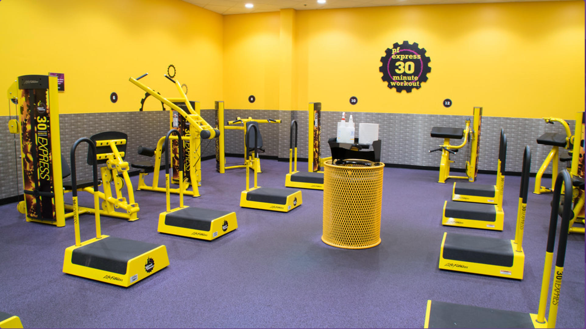 Yellow Wabash Valley Signature Perforated Commercial Trash Receptacle Inside of Planet Fitness