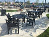 Black Yorktown 48 inch round slat tables with matching arm chairs on a shopping center plaza, model YO2G33C, round patio table with umbrella hole