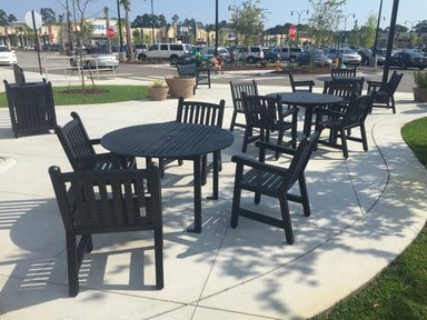 Black Yorktown 48 inch round slat tables with matching arm chairs on a shopping center plaza, model YO2G33C, round patio table with umbrella hole