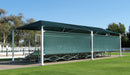 Green outdoor USA Shade 6-Post Hip with a large screen on a grassy area with trees in the background