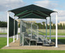 Outdoor sports facility with a green USA Shade 6-Post Hip and metal bleacher leading to a dugout.