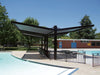 USA Shade Slanted Cantilever Framed double side Unit by a pool with trees and building in the background