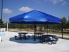 Blue outdoor USA Shade Coolbrella over picnic tables with a park in the background