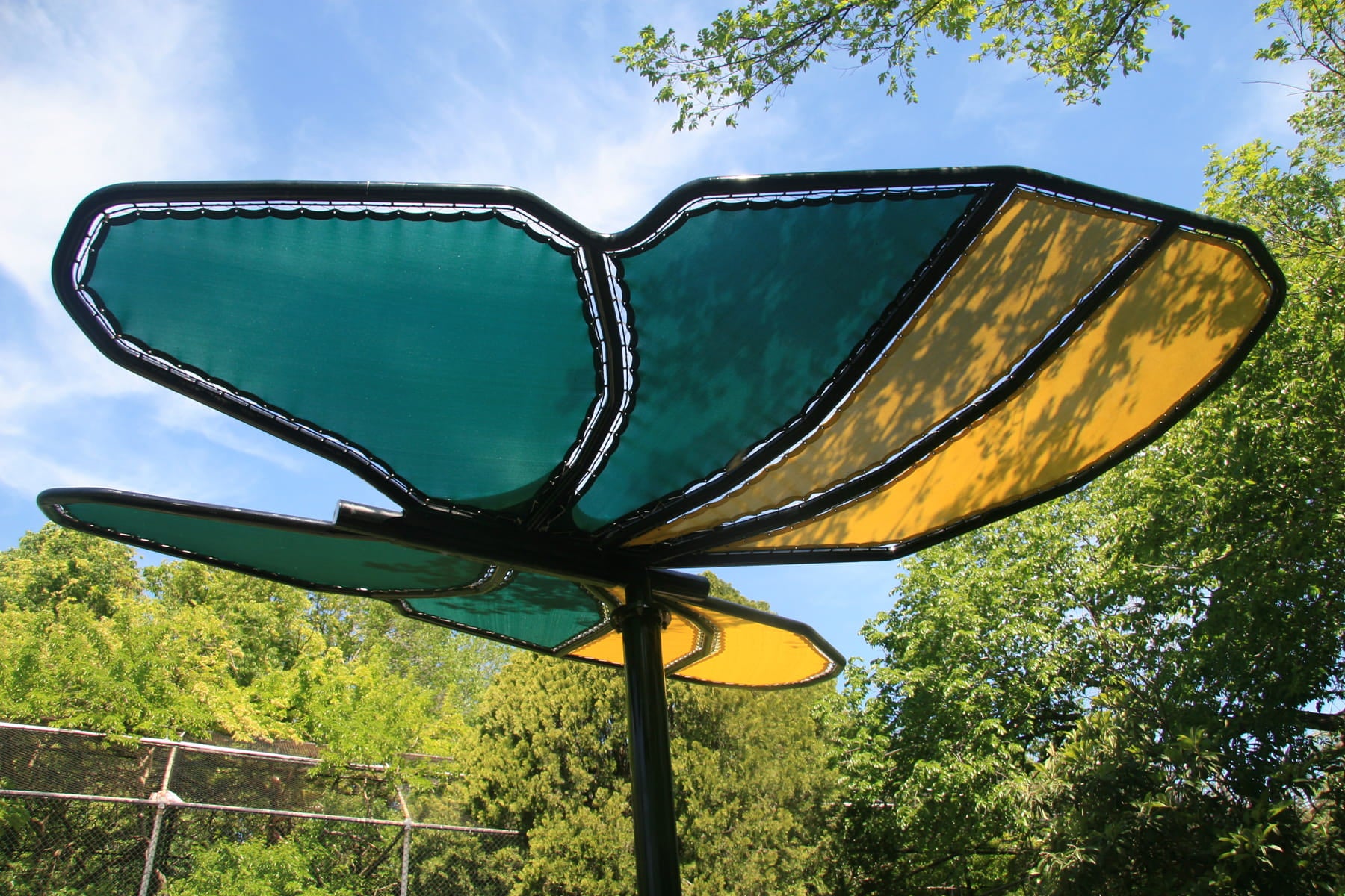 Decorative USA Shade Butterfly Wings Shade with green and yellow wings against a blue sky and tree background