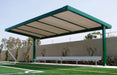 USA Shade Slanted Cantilever Framed Covered seating area with a bench on a sports field