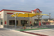 Fast food restaurant with a yellow USA Shade Panorama Cantilever and visible brand logo.