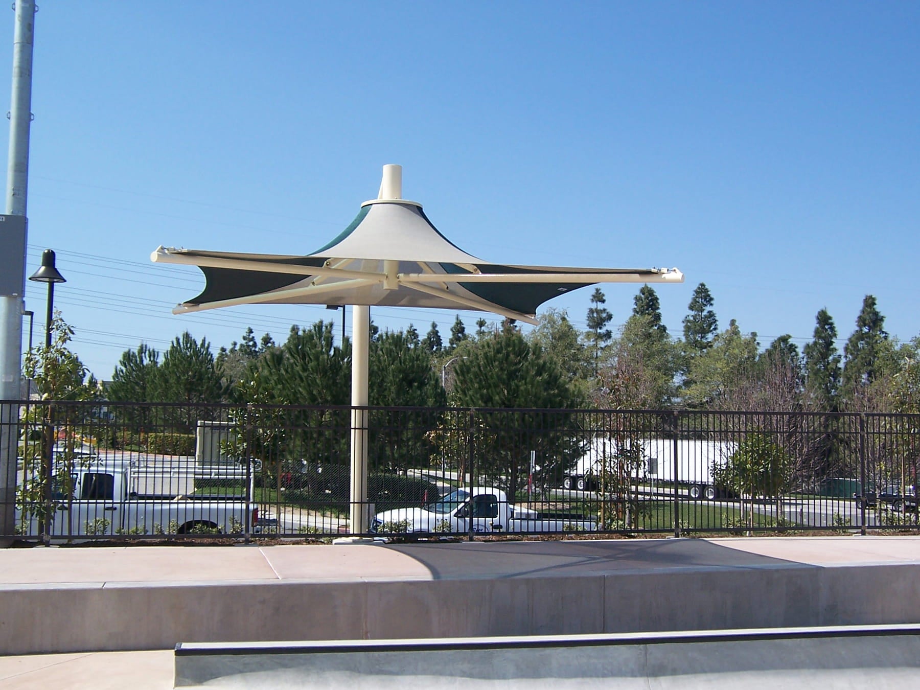 Modern outdoor USA Shade Solana Cantilever structure with cars and trees in the background